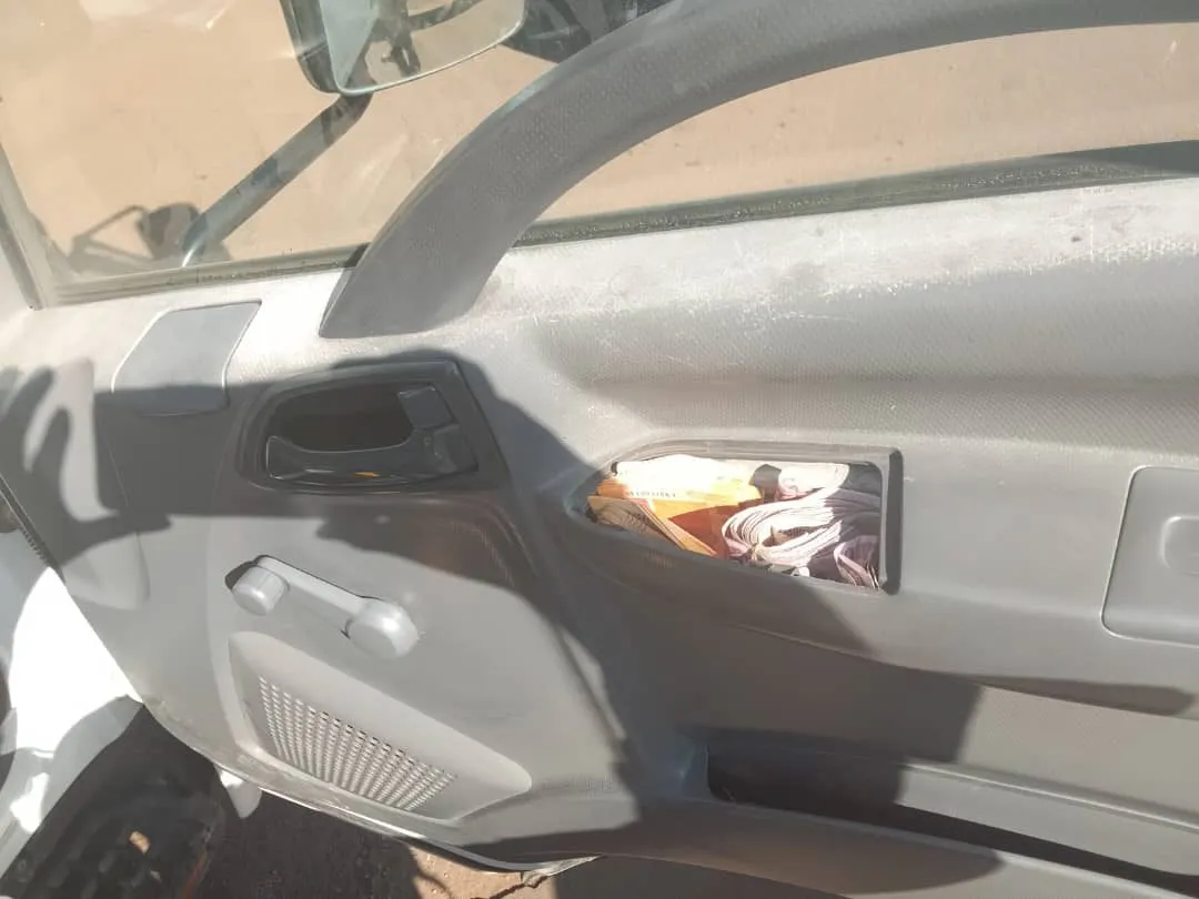 The opened panel of the false compartment behind the cab