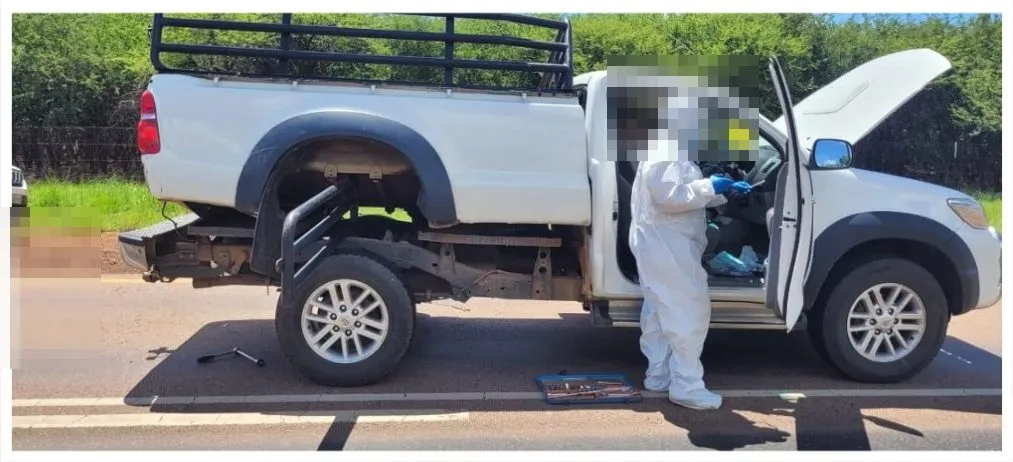 The intercepted bakkie in Limpopo with a forensic officer at the open door; faces pixelated