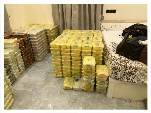 Bricks of seized methamphetamine and heroin stacked on the floor, Tanzania, December 2023