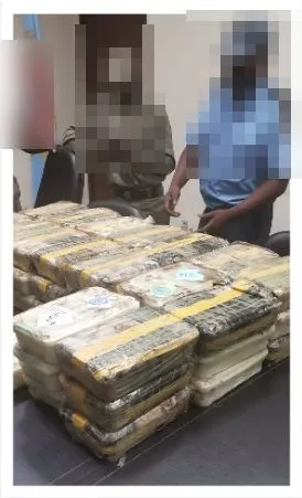 Officers with the stacked Vilankulo seizure; faces pixelated