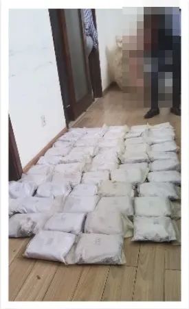 Packages from the Vilankulo seizure laid along a corridor; person pixelated